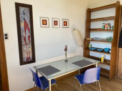 a dining room with a table and blue chairs at Huis krekelhof in Antwerp