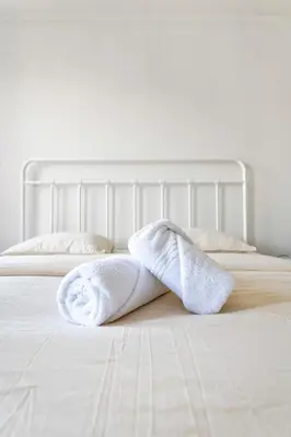a pair of towels laying on a bed at Rooftop appartement in Sint-Niklaas