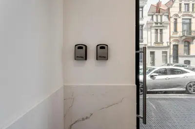 a bathroom with a glass door with a view of a street at Rooftop appartement in Sint-Niklaas