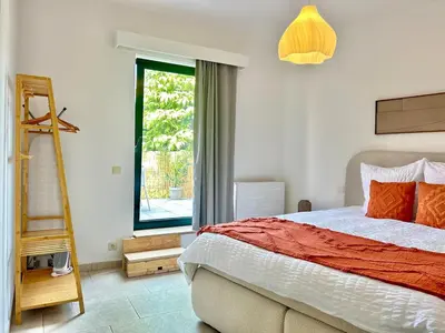 a bedroom with a bed and a ladder and a window at Apartment for 6 people - near Brussels & Airport in Wezembeek-Oppem