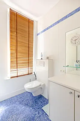 a white bathroom with a toilet and a sink at Maison du Cinquantenaire - The Residential in Brussels