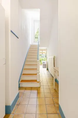 a hallway with stairs in a house at Maison du Cinquantenaire - The Jubilee Loft in Brussels