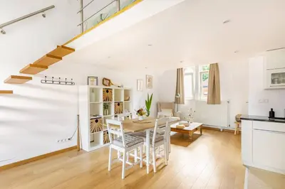 a kitchen and dining room with a table and chairs at Maison du Cinquantenaire - The Jubilee Loft in Brussels
