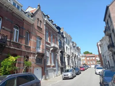 a city street with cars parked on the street at Maison du Cinquantenaire - The Jubilee Loft in Brussels