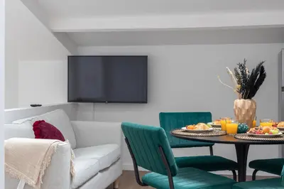 a living room with a couch and a table with food on it at Chez Lilou et Babette 4 appartements 2 chambres in Brussels