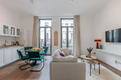 a living room with a couch and a table at Chez Lilou et Babette 4 appartements 2 chambres in Brussels
