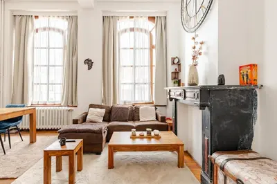 a living room with a couch and a table at Luxury home at Grand Place & Manneken Pis in Brussels