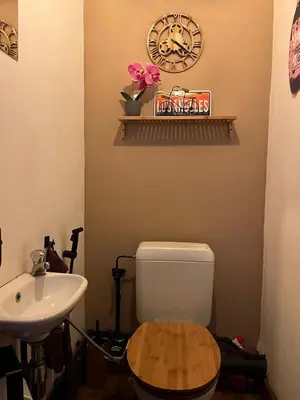 a bathroom with a toilet and a sink and a clock at Luxury home at Grand Place & Manneken Pis in Brussels