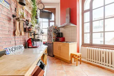 a kitchen with a counter and a brick wall at Luxury home at Grand Place & Manneken Pis in Brussels