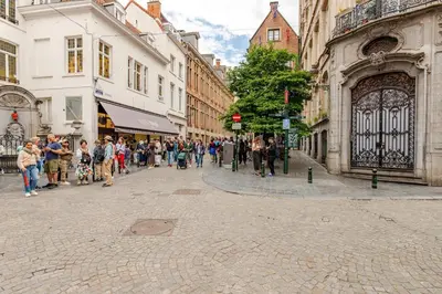 a group of people walking down a city street at Luxury home at Grand Place & Manneken Pis in Brussels