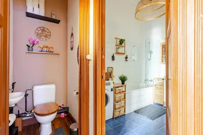 a bathroom with a toilet and a sink and a tub at Luxury home at Grand Place & Manneken Pis in Brussels