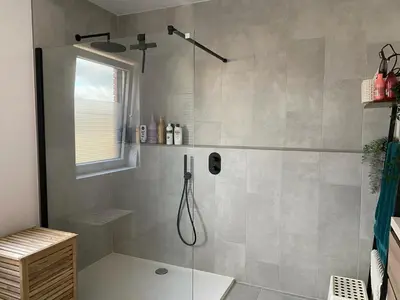 a shower with a glass door in a bathroom at Radja in Boom