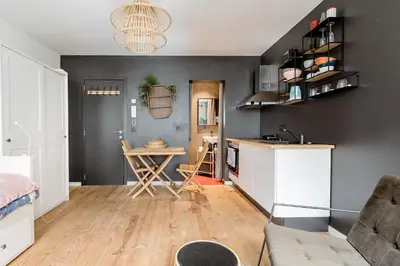 a kitchen and living room with a table and a couch at Charming Private Studio - Nearby Antwerp Central Station in Antwerp