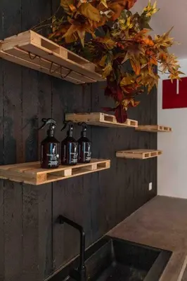 a kitchen with wooden shelves above a sink at Charming Private Studio - Nearby Antwerp Central Station in Antwerp