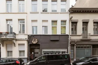 a black van parked in front of a building at Charming Private Studio - Nearby Antwerp Central Station in Antwerp