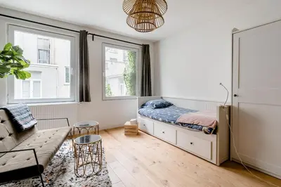 a bedroom with a bed and a couch at Charming Private Studio - Nearby Antwerp Central Station in Antwerp