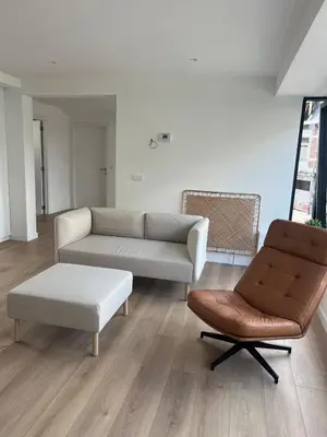 a living room with a couch and a chair at Libre in Temse