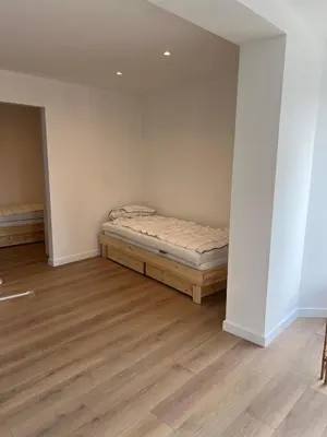 a bedroom with a bed in the corner of a room at Libre in Temse