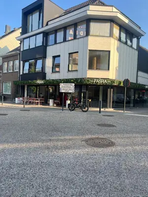 a building on a street with a sign in front of it at Libre in Temse