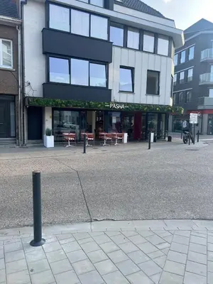 a building with tables and chairs in front of it at Libre in Temse