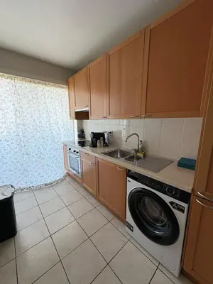 a kitchen with a washing machine and a sink at Cosy apartment near Zaventem Airport in Brussels
