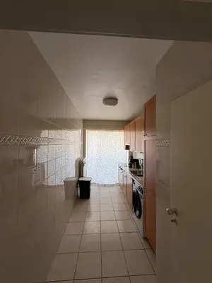 a kitchen with a washer and dryer in a room at Cosy apartment near Zaventem Airport in Brussels