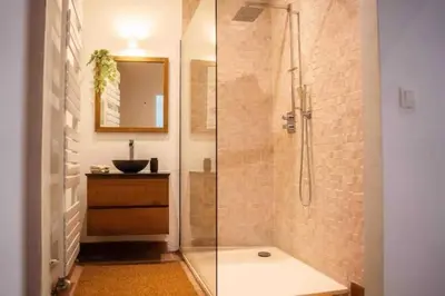 a bathroom with a glass shower and a sink at Havre de Paix à Bruxelles avec piscine et sauna in Brussels
