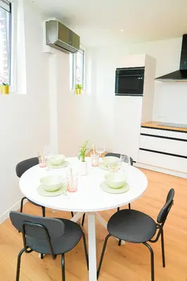 a white table and chairs in a room at Modern 1BR & 1LR Apartment, 10 min Walk to City Center in Ghent