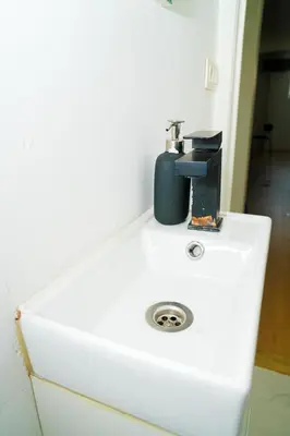 a white sink with a faucet on top of it at Modern 1BR & 1LR Apartment, 10 min Walk to City Center in Ghent