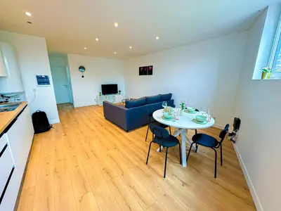 a living room with a table and a couch at Modern 1BR & 1LR Apartment, 10 min Walk to City Center in Ghent