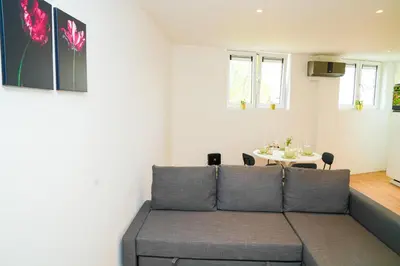 a living room with a couch and a table at Modern 1BR & 1LR Apartment, 10 min Walk to City Center in Ghent