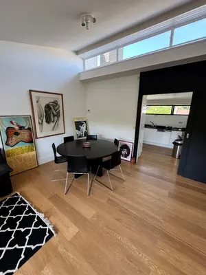a living room with a black table and chairs at Villa 'L' in Brussels