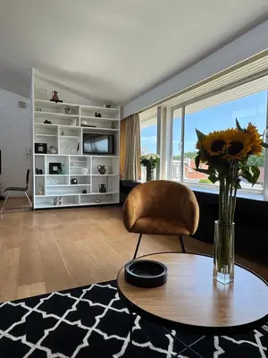 a living room with a table and a chair at Villa 'L' in Brussels