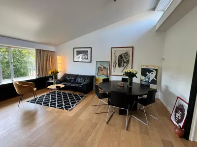 a living room with a table and a couch at Villa 'L' in Brussels