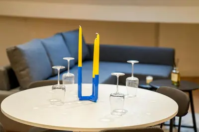 a table with three wine glasses with candles on it at Chic & Modern 1BR & 1LR Apt, 12 Min Walk to Rabot in Ghent