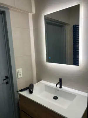 a bathroom with a white sink and a mirror at Casa Duffla in Duffel