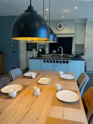 a wooden table with plates on it in a kitchen at Casa Duffla in Duffel