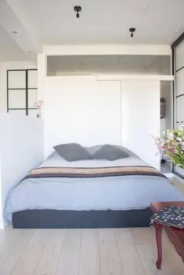 a bedroom with a large bed and a wooden floor at Cozy apartment - Super central in Brussels