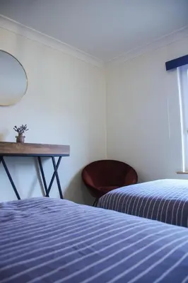 a bedroom with two beds and a table and a chair at Aurelia in Zemst