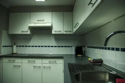a kitchen with white cabinets and a sink at Aurelia in Zemst