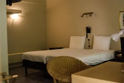 a hotel room with two beds and a table at Hotel Pacific in Weelde