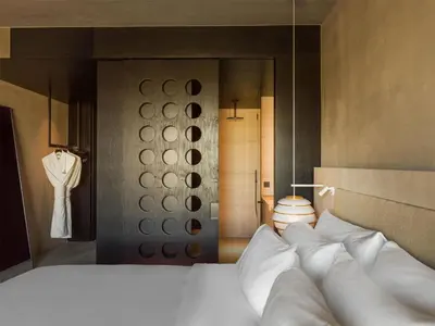 a bedroom with a large bed with white pillows at Radisson Collection The National Hotel, Brussels in Zaventem