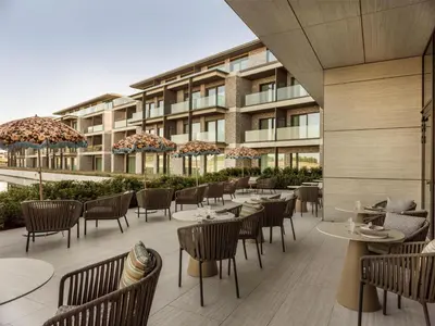 a patio with tables and chairs and a building at Radisson Collection The National Hotel, Brussels in Zaventem