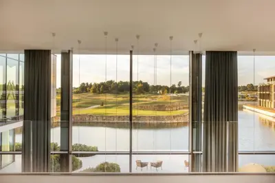 a room with a large window with a view of a golf course at Radisson Collection The National Hotel, Brussels in Zaventem
