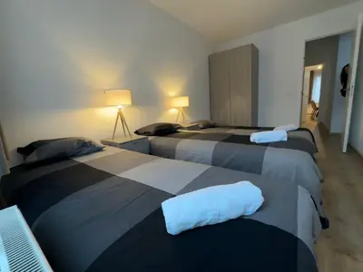 two beds in a room with two beds sidx sidx sidx at Modern 2 Bedroom Apartment for 6 - City Center in Brussels