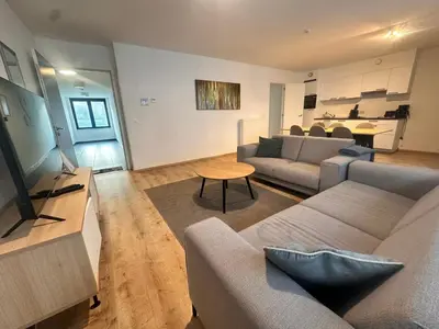 a living room with a couch and a table at Modern 2 Bedroom Apartment for 6 - City Center in Brussels