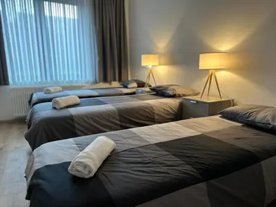 a hotel room with three beds with towels on them at Modern 2 Bedroom Apartment for 6 - City Center in Brussels
