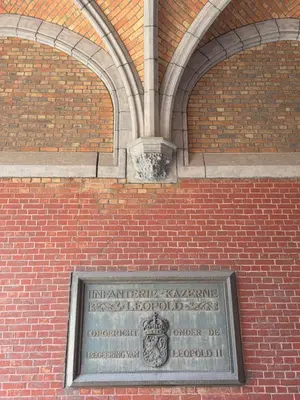 a plaque on the side of a brick building at JAM Ghent in Ghent