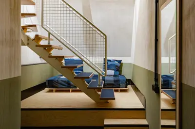 a staircase in a room with blue pillows at JAM Ghent in Ghent