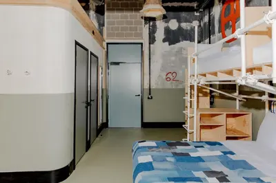 a room with a bunk bed and a doorway at JAM Ghent in Ghent